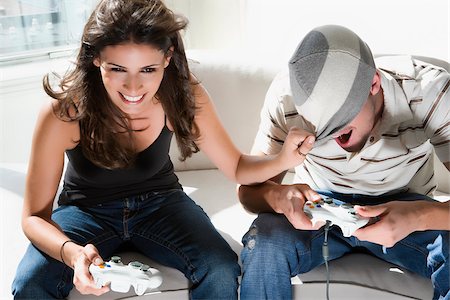 Competitive boyfriend and girlfriend playing video games funny Stock Photo