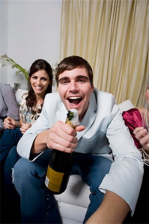 Portrait of a young man with her friends celebrating a party Stock Photo - Premium Royalty-Free, Code: 625-02930223