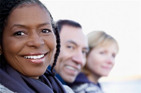 Close-up of a senior woman smiling with her friends Stock Photo - Premium Royalty-Free, Code: 625-02930247