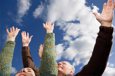 Close-up of a couple with their arms raised Stock Photo - Premium Royalty-Free, Code: 625-02930248