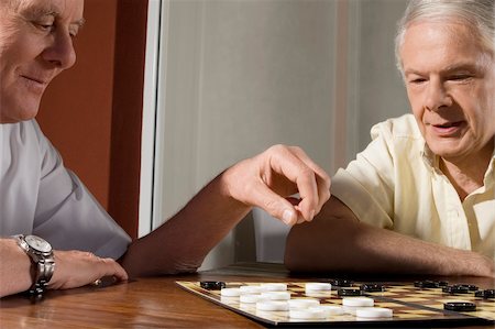 Two senior men playing checkers Stock Photo - Premium Royalty-Free, Code: 625-02930281