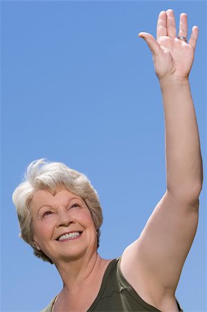 person's - Low angle view of a senior woman waving her hand Foto de stock - Sin royalties Premium, Código: 625-02930290