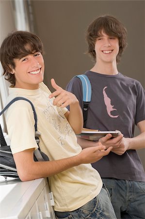 ethnic boy backpack - Portrait of a teenage boy and a young man smiling together Stock Photo - Premium Royalty-Free, Code: 625-02930330