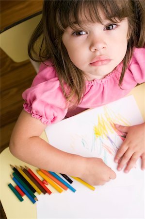 desk directly above - Portrait of a girl drawing on a sheet of paper Stock Photo - Premium Royalty-Free, Code: 625-02930525