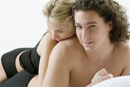 sexual issues - Close-up of a young couple lying on the bed Stock Photo - Premium Royalty-Free, Code: 625-02930615