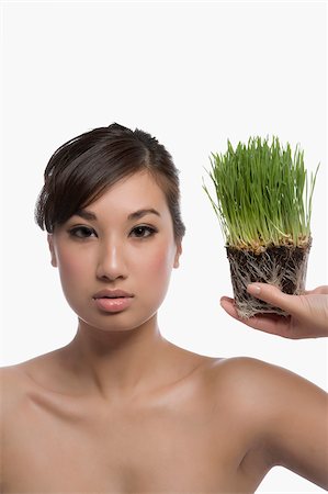 simsearch:625-02267557,k - Portrait of a young woman holding wheatgrass Stock Photo - Premium Royalty-Free, Code: 625-02930680