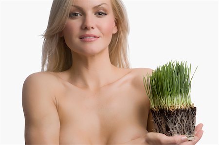 simsearch:625-02930713,k - Portrait of a young woman holding wheatgrass Stock Photo - Premium Royalty-Free, Code: 625-02930710