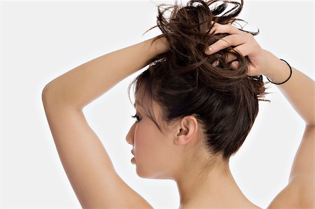 simsearch:625-02267557,k - Close-up of a young woman with her hands in her hair Stock Photo - Premium Royalty-Free, Code: 625-02930736