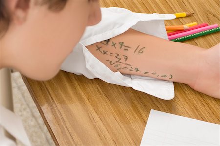 elementary student uniform - Close-up of a schoolboy copying in an examination Stock Photo - Premium Royalty-Free, Code: 625-02930936