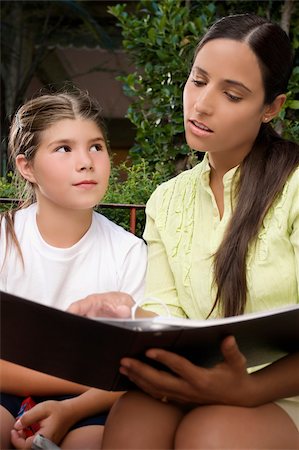 simsearch:625-02930963,k - Female teacher checking a file of a schoolgirl Stock Photo - Premium Royalty-Free, Code: 625-02930968