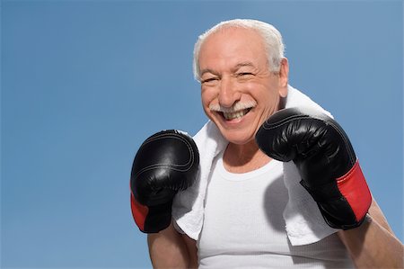 Close-up of a senior man in boxing pose Stock Photo - Premium Royalty-Free, Code: 625-02930997