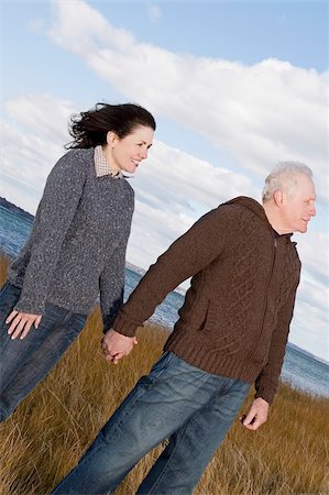 Couple standing on the beach with holding hands of each other Stock Photo - Premium Royalty-Free, Code: 625-02931091