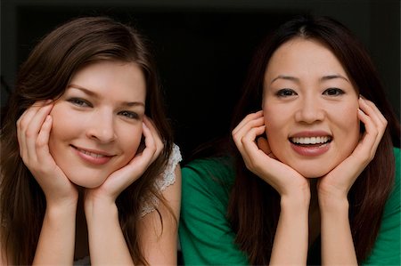 friends black background - Portrait of two young women smiling Stock Photo - Premium Royalty-Free, Code: 625-02931125