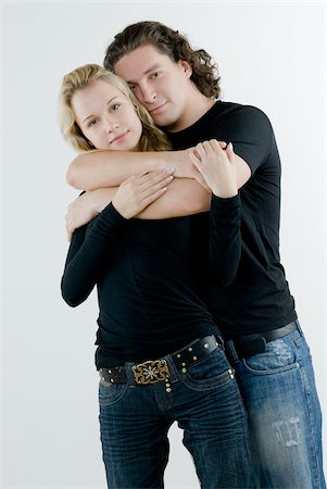 Portrait of a young man embracing a young woman from behind Stock Photo - Premium Royalty-Free, Code: 625-02931237