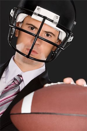 simsearch:625-02932995,k - Close-up of a businessman wearing a football helmet Stock Photo - Premium Royalty-Free, Code: 625-02931249
