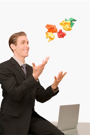 Businessman throwing crumpled papers Stock Photo - Premium Royalty-Free, Code: 625-02931260