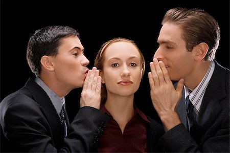 Side profile of two businessmen whispering to a businesswoman Stock Photo - Premium Royalty-Free, Code: 625-02931301