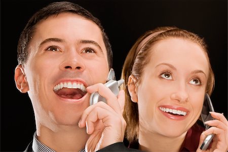 simsearch:625-02933255,k - Chefs d'entreprise parlent sur les téléphones mobiles et souriant Photographie de stock - Premium Libres de Droits, Code: 625-02931356