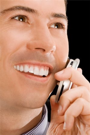 simsearch:625-02933255,k - Gros plan d'un homme d'affaires, parler sur un téléphone mobile et souriant Photographie de stock - Premium Libres de Droits, Code: 625-02931387