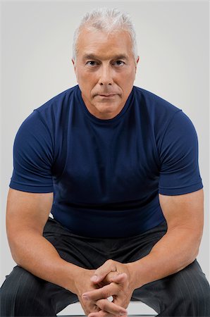 senior muscles - Portrait of a senior man sitting with his hands clasped Stock Photo - Premium Royalty-Free, Code: 625-02931515