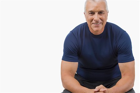 senior men body builders - Portrait of a senior man sitting with his hands clasped and smiling Stock Photo - Premium Royalty-Free, Code: 625-02931542