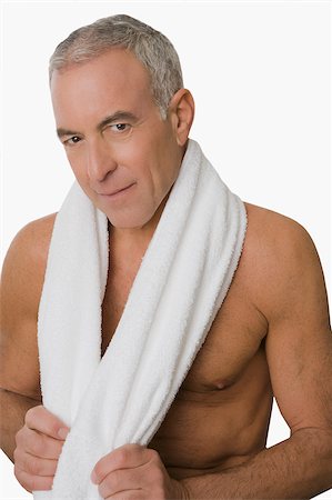 Portrait of a senior man smiling with a towel around his neck Stock Photo - Premium Royalty-Free, Code: 625-02931562
