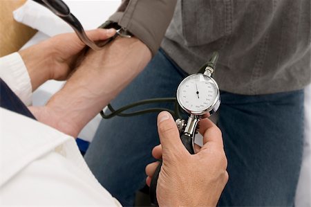 High angle view of a doctor checking a patient's blood pressure Stock Photo - Premium Royalty-Free, Code: 625-02931589