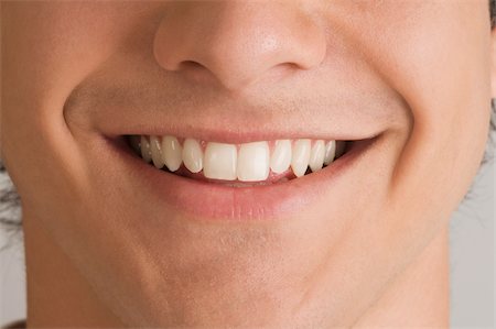 extreme close up - Close-up of a young man smiling Stock Photo - Premium Royalty-Free, Code: 625-02931640