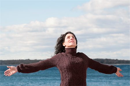 extend the arms - Mature woman standing on the beach with her arms outstretched Stock Photo - Premium Royalty-Free, Code: 625-02931843