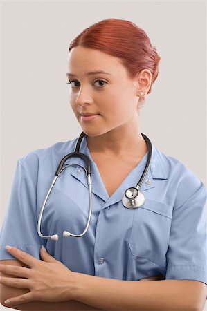 portrait and woman and closeup and arms - Portrait of a female doctor with her arms crossed and smiling Stock Photo - Premium Royalty-Free, Code: 625-02931873