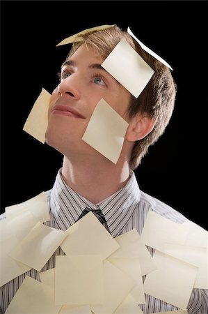 Close-up of a businessman covered with adhesive notes and day dreaming Foto de stock - Sin royalties Premium, Código: 625-02931884