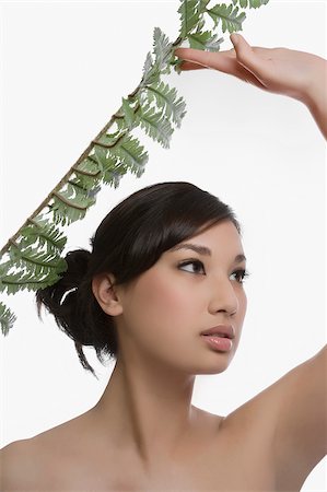simsearch:625-02267557,k - Close-up of a young woman holding a fern Stock Photo - Premium Royalty-Free, Code: 625-02931928