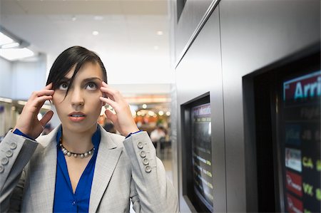 Businesswoman suffering from a headache at an airport Stock Photo - Premium Royalty-Free, Code: 625-02932162