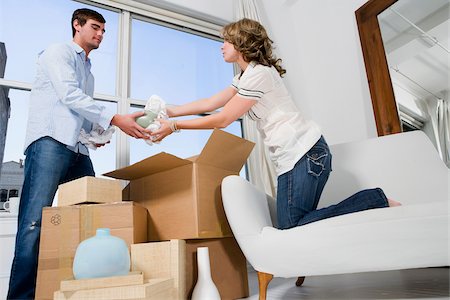 Young couple unpacking cardboard boxes Stock Photo - Premium Royalty-Free, Code: 625-02932248