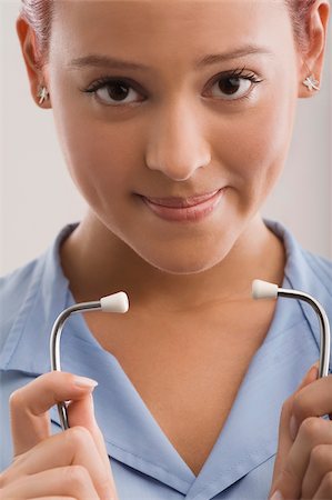 simsearch:625-02929220,k - Portrait of a female doctor holding a stethoscope and smiling Stock Photo - Premium Royalty-Free, Code: 625-02932277