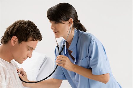 female doctors checking males - Female doctor examining a patient Stock Photo - Premium Royalty-Free, Code: 625-02932425