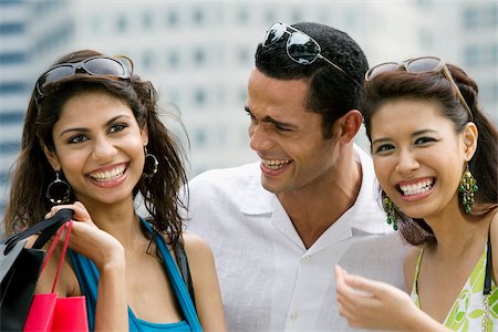 Close-up of a mid adult man with two young women smiling Stock Photo - Premium Royalty-Free, Code: 625-02932426