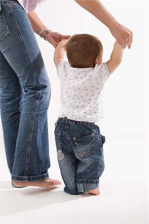 Low section view of a woman walking with her baby boy Stock Photo - Premium Royalty-Free, Code: 625-02932448