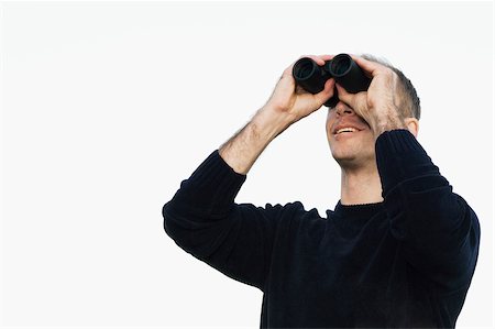 rivelare - Close-up of a mid adult man looking through binoculars Fotografie stock - Premium Royalty-Free, Codice: 625-02932473