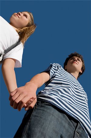 Low angle view of a teenage boy holding hand of his sister Stock Photo - Premium Royalty-Free, Code: 625-02932501