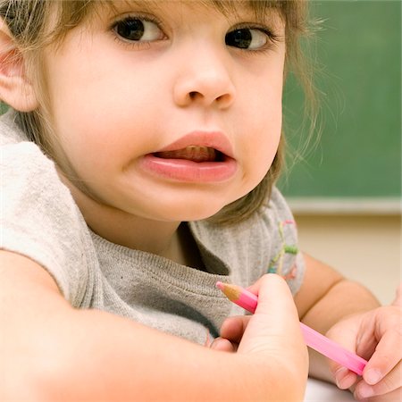 simsearch:625-02930525,k - Close-up of a girl holding a colored pencil and making a face Foto de stock - Sin royalties Premium, Código: 625-02932604