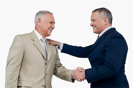 fusionar - Two businessmen shaking hands and smiling Foto de stock - Sin royalties Premium, Código: 625-02932730