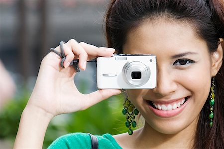 Close-up of a young woman photographing with a digital camera Stock Photo - Premium Royalty-Free, Code: 625-02932752