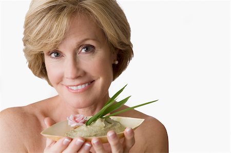 Portrait of a mature woman holding a bowl of face pack Stock Photo - Premium Royalty-Free, Code: 625-02932760