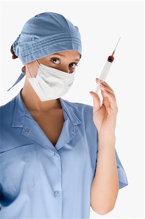 doctor syringe close up - Portrait of a female surgeon holding a syringe Stock Photo - Premium Royalty-Free, Code: 625-02932777