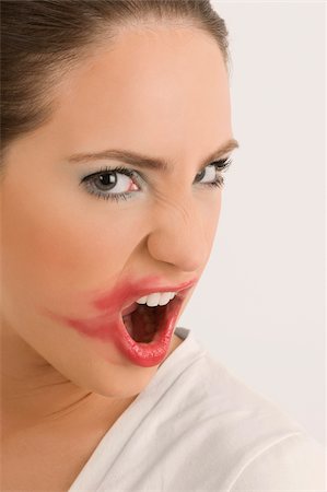 distaste - Portrait of a young woman with her messy lips Stock Photo - Premium Royalty-Free, Code: 625-02932822