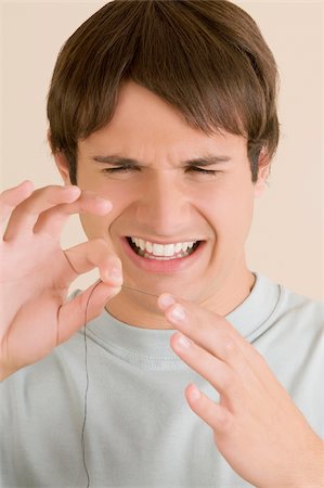 distaste - Close-up of a young man pinching a needle in his finger Stock Photo - Premium Royalty-Free, Code: 625-02932845