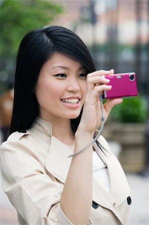 Close-up of a young woman photographing with a digital camera Stock Photo - Premium Royalty-Free, Code: 625-02932864