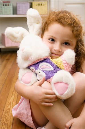 stuffed animals bunny - Portrait of a girl hugging a stuffed toy Stock Photo - Premium Royalty-Free, Code: 625-02932861