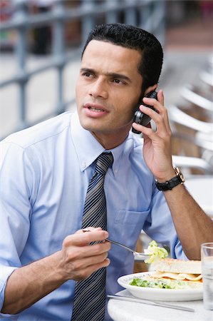 rolled up sleeves - Businessman talking on a mobile phone during lunch Stock Photo - Premium Royalty-Free, Code: 625-02932898